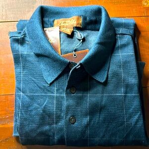 Blue polo shirt made by Tasso Elba. Size is Large